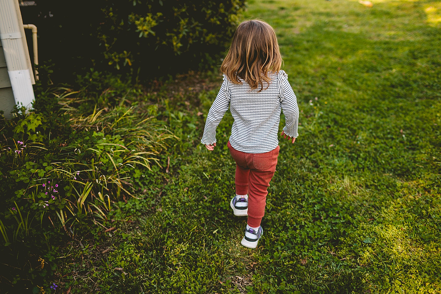 Girl walking away in the yard