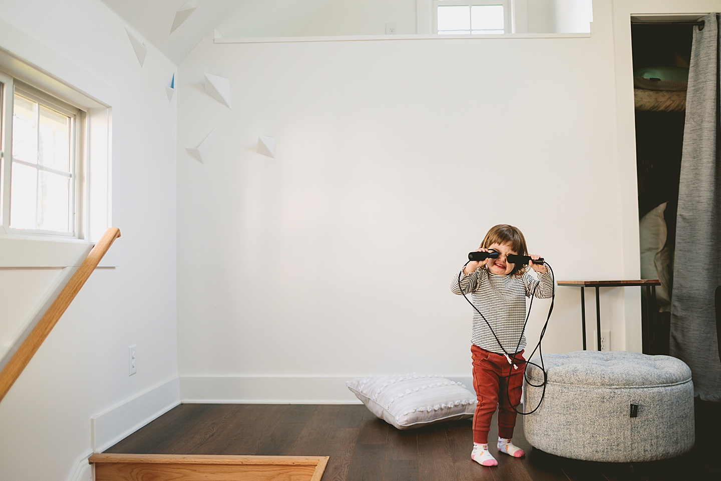 Girl playing with remote controls in living room