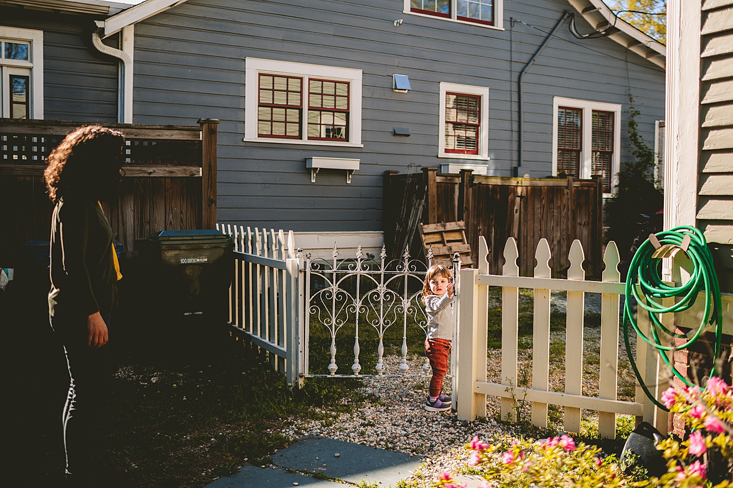 Little girl walking through garden gate