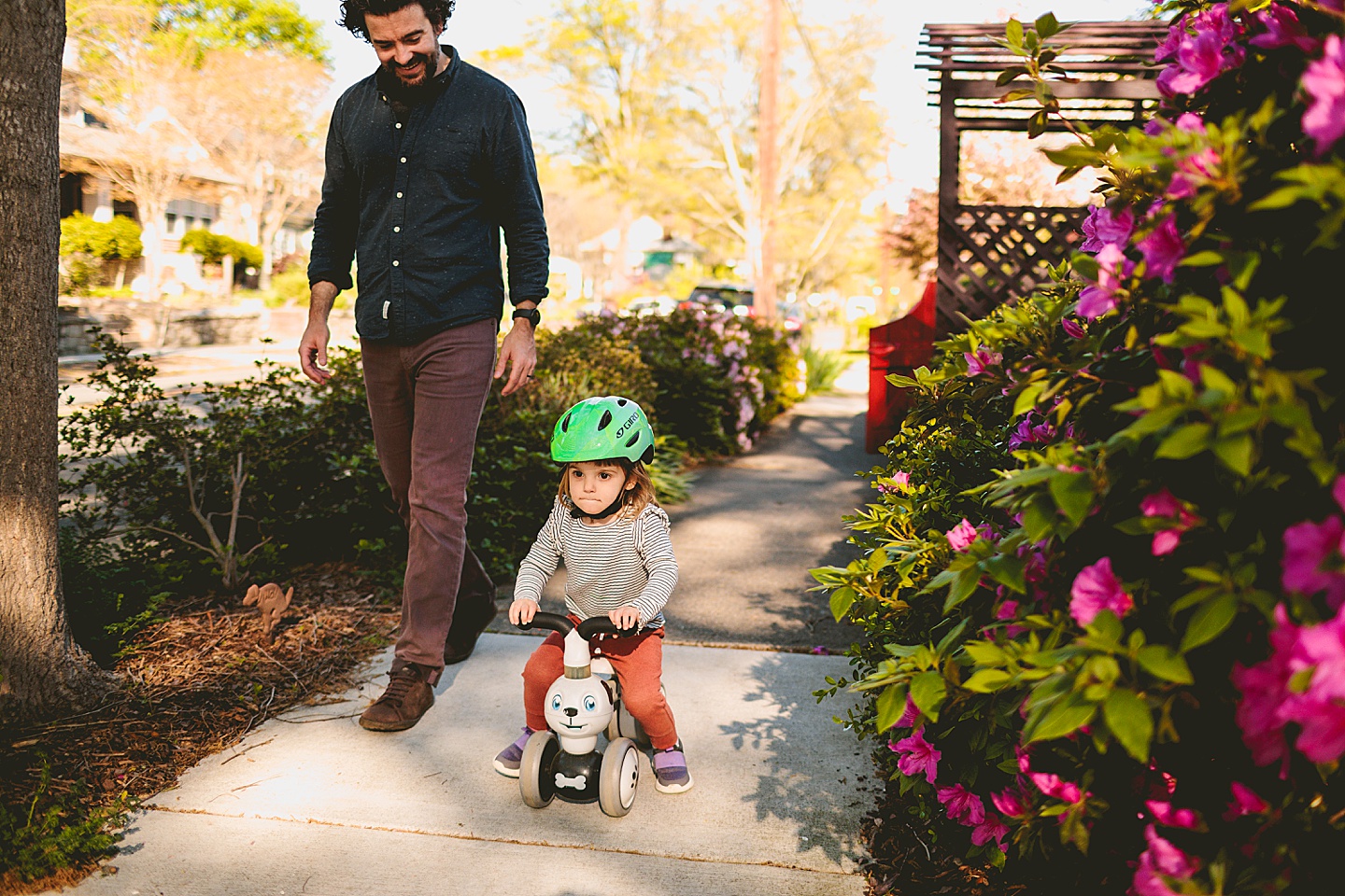 Girl riding a bike on the sidewalk during Durham family photographs