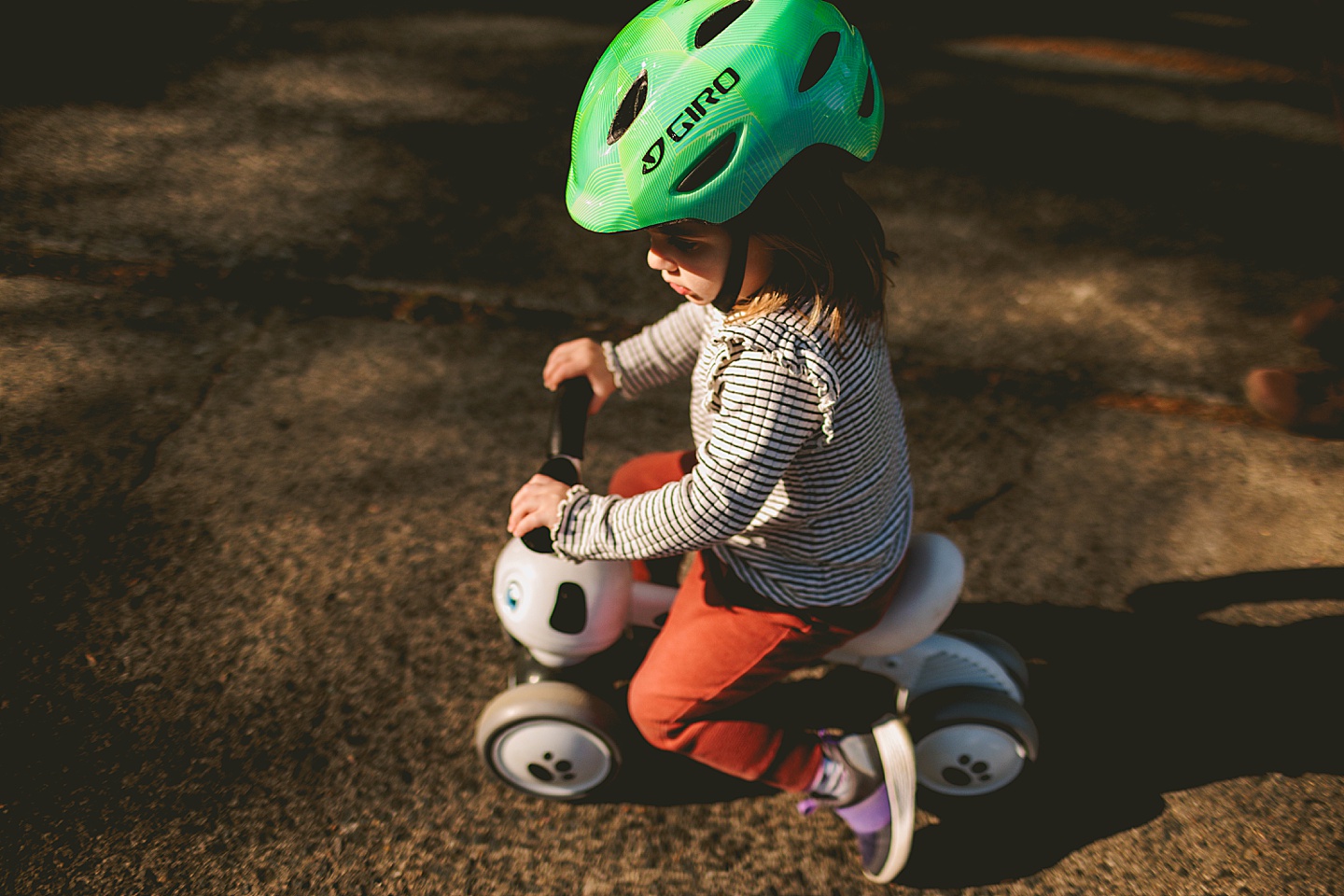 Girl riding a bike on the sidewalk during Durham family photographs