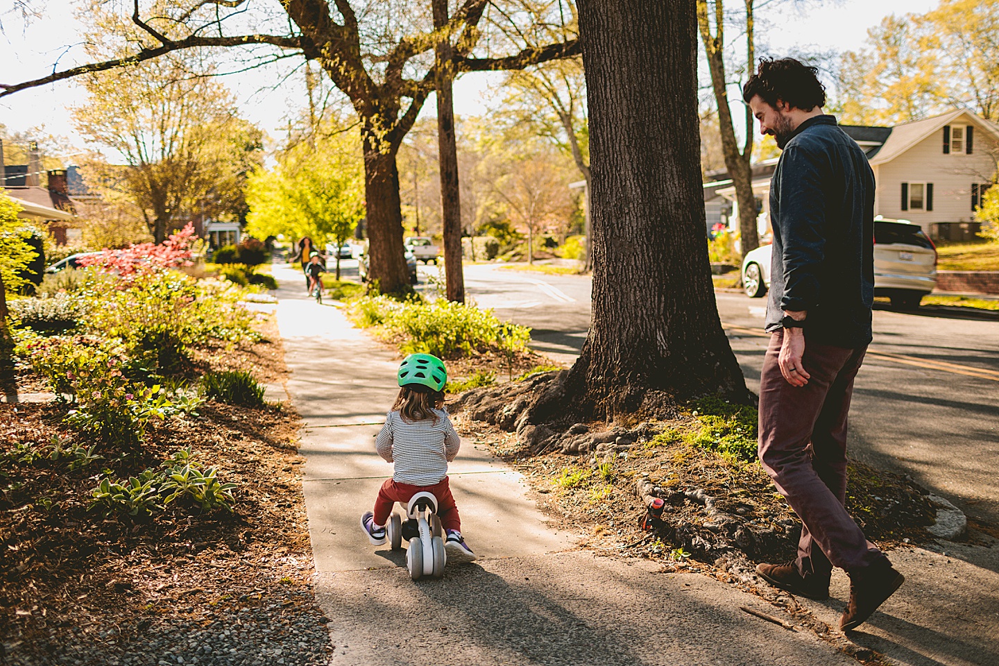 Girl riding a bike on the sidewalk during Durham family photographs