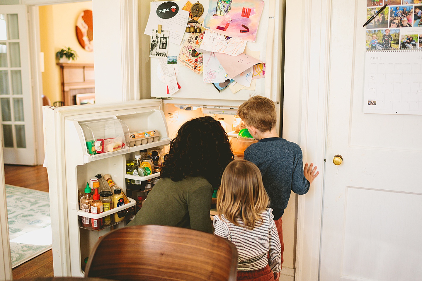 Kids helping mom in the fridge