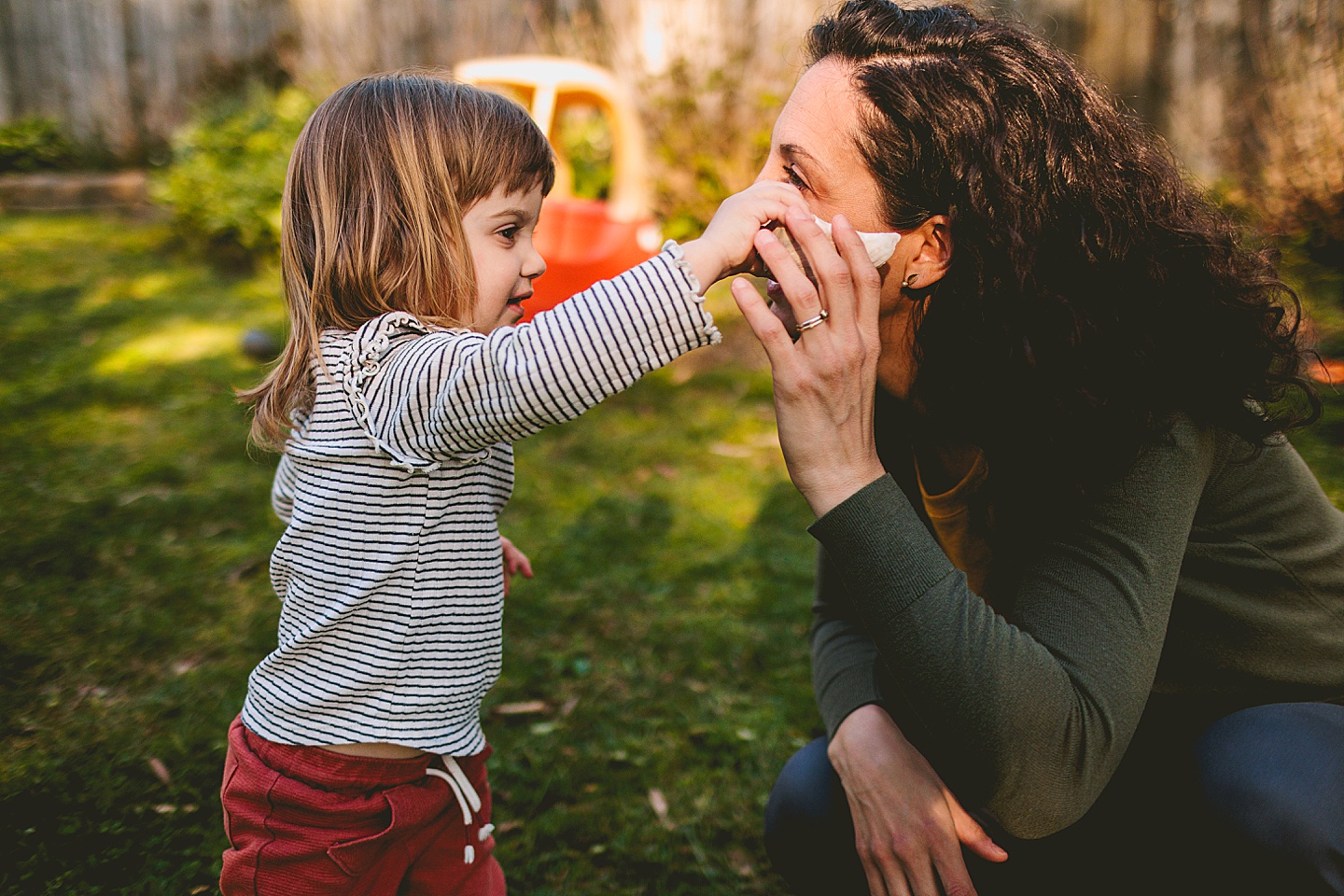 Girl helping mom listen to a seashell