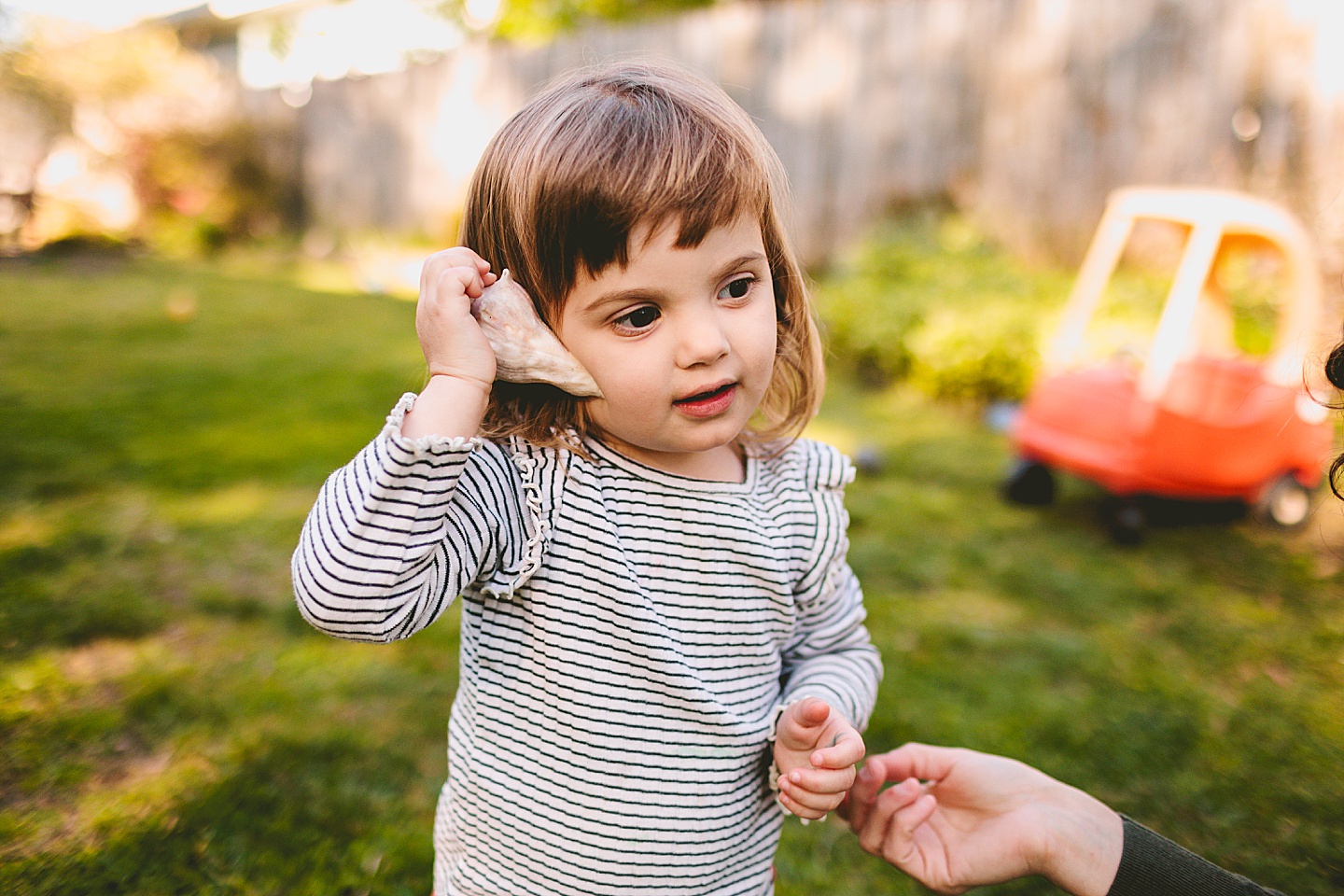 Girl listening to seashell