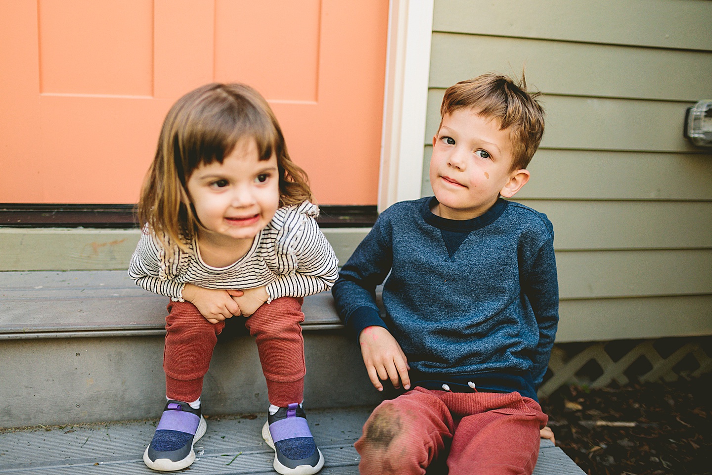 Brother and sister sitting on steps