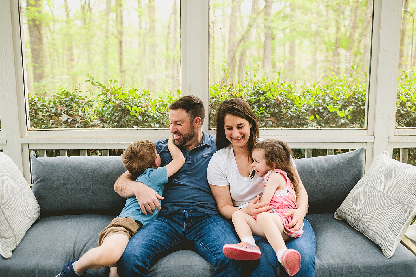 Raleigh family photographer takes pictures of family on couch at home