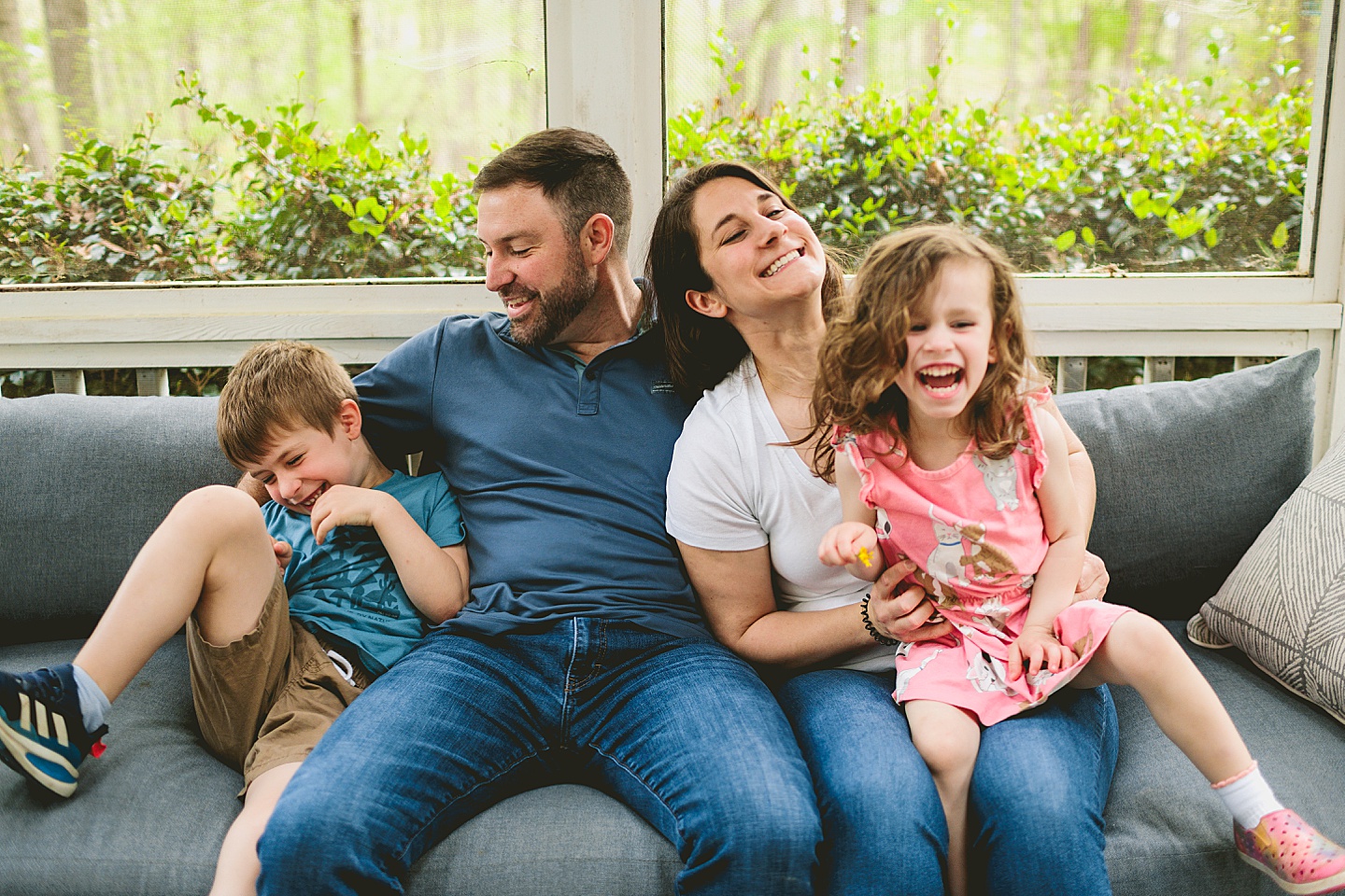 Raleigh family photographer takes pictures of family on couch at home