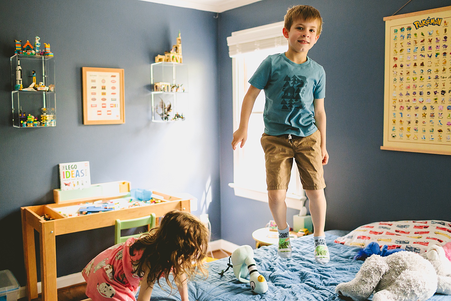 Kid jumping on a bed in house