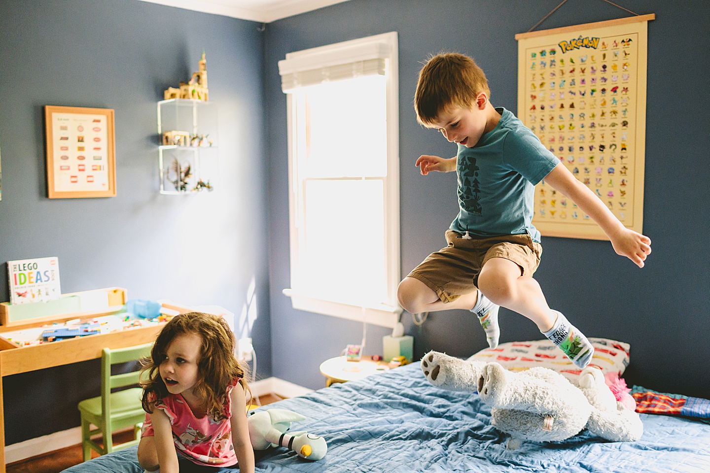 Kid jumping on a bed in house