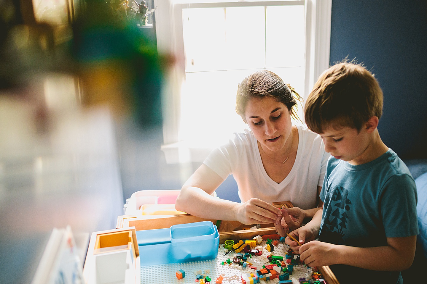 Mom building Legos with son during family photos at home in Raleigh