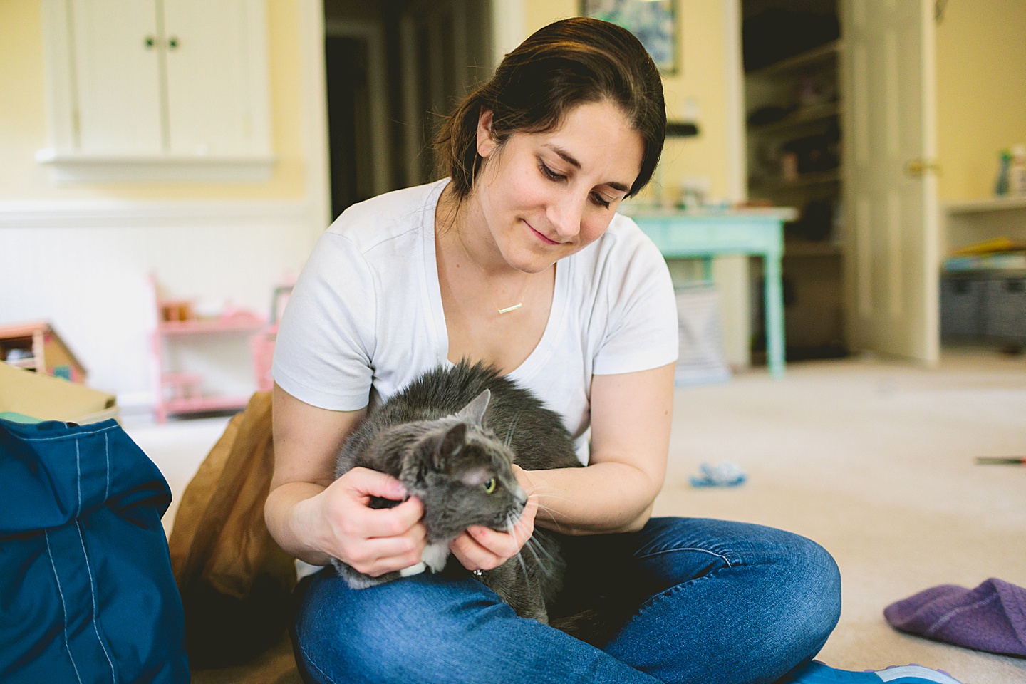 Mom holding gray and white cat