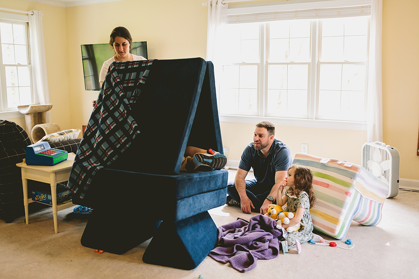 Family building a fort at home