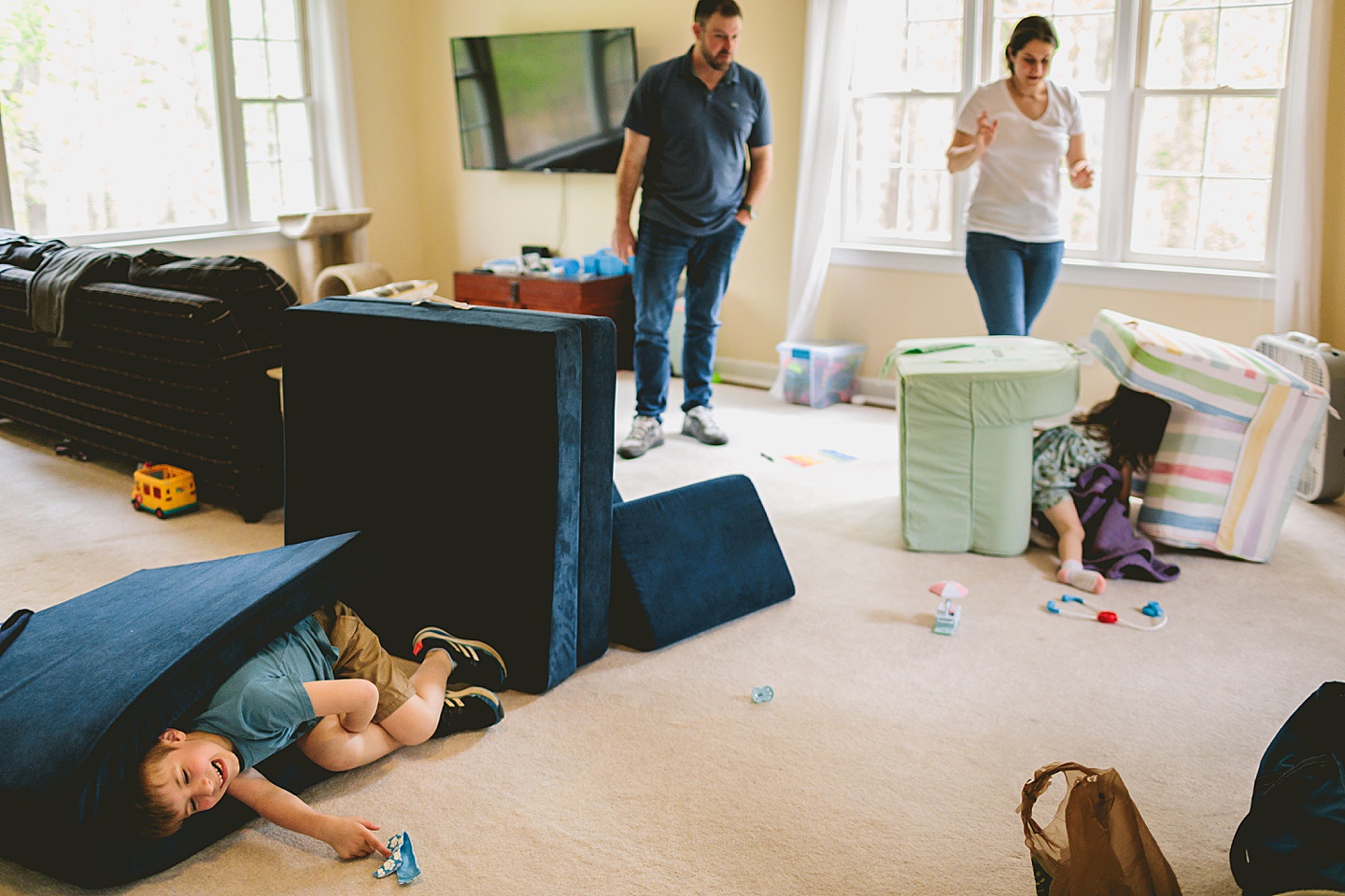 Family building a fort at home