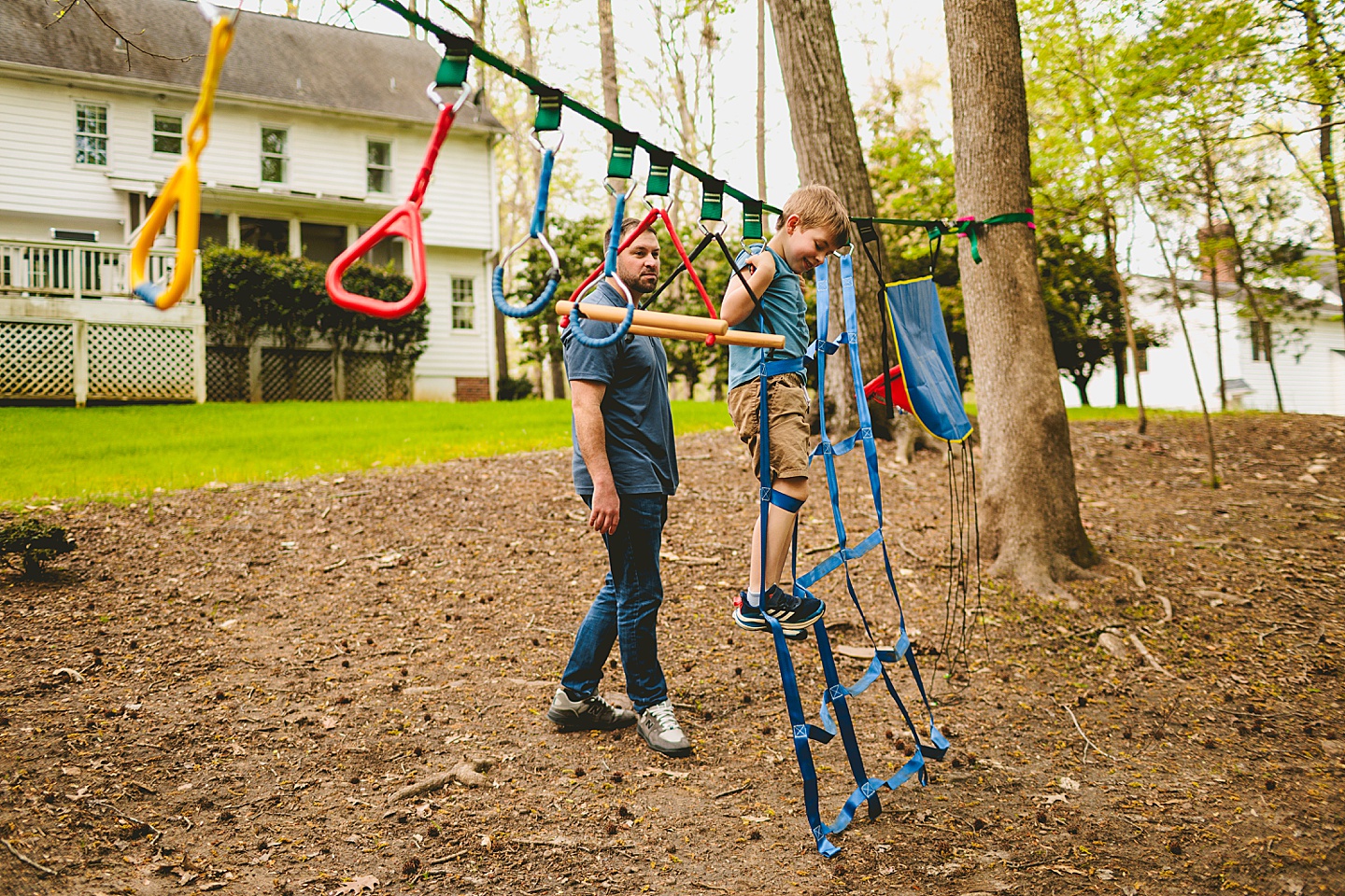 Boy climbing slack line in backyard