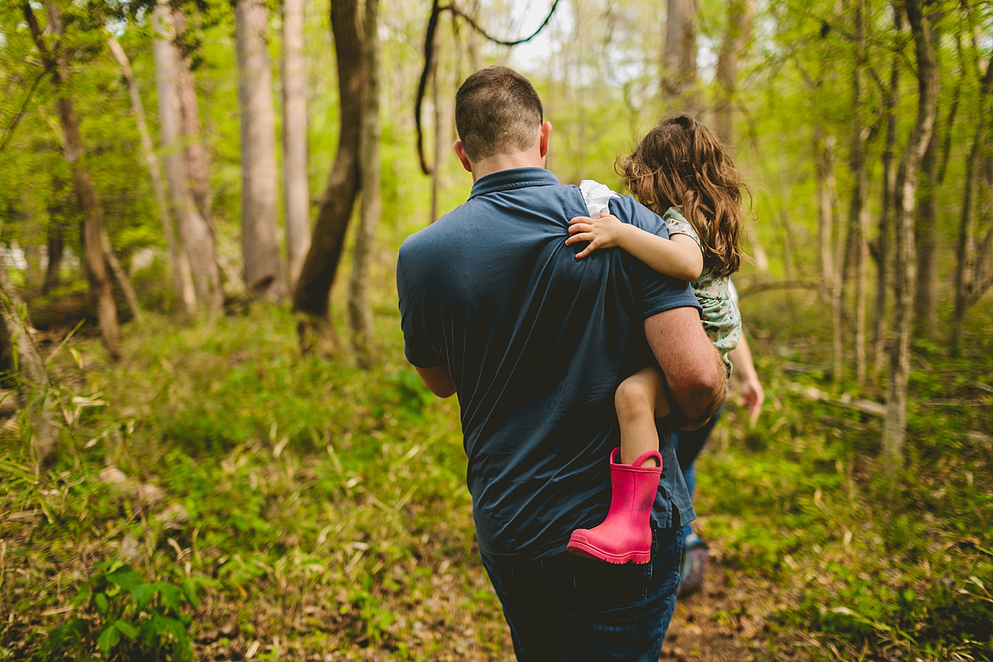 Family walking on a trail through the woods