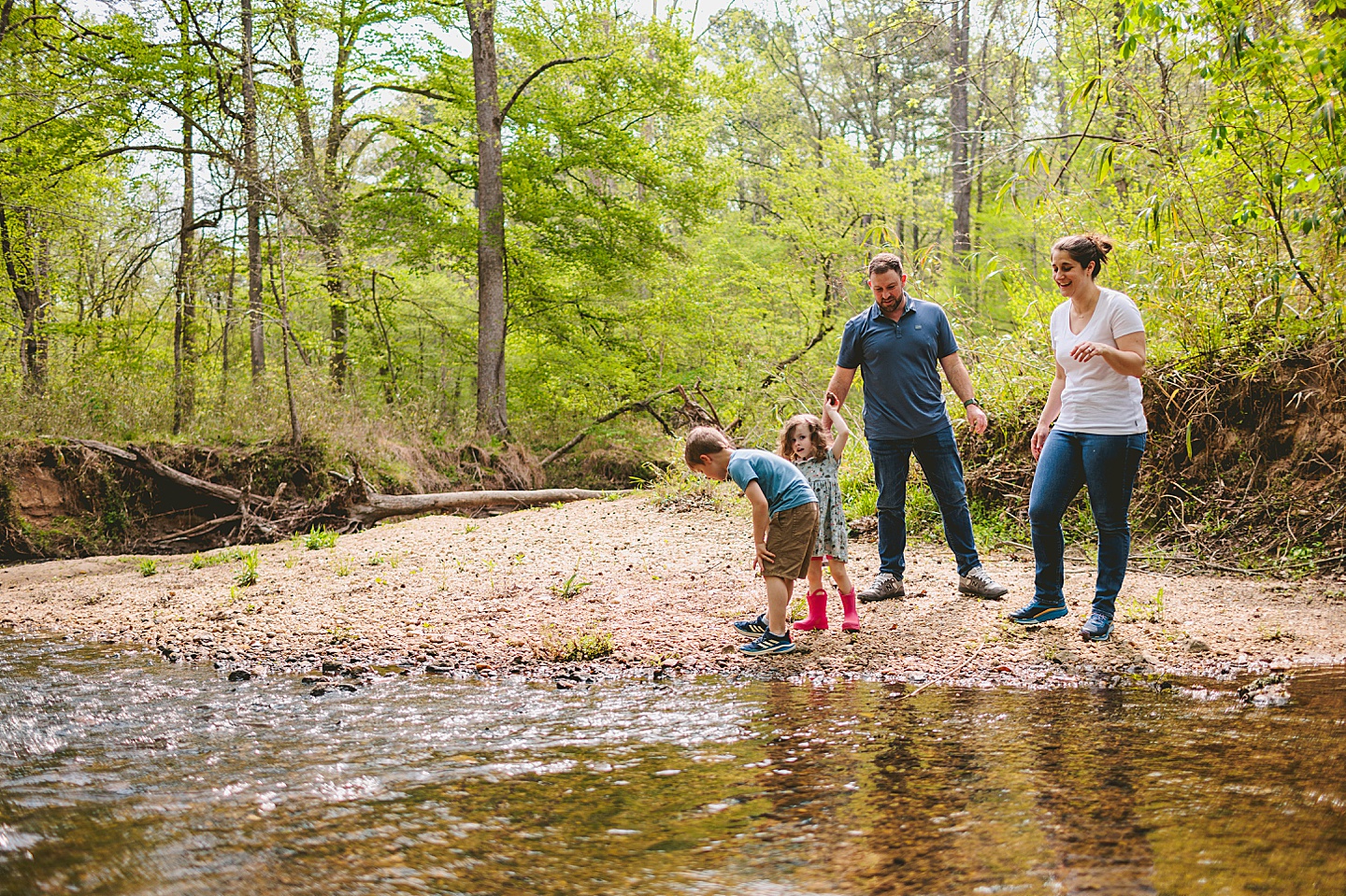 Family playing in creek by their house in Raleigh