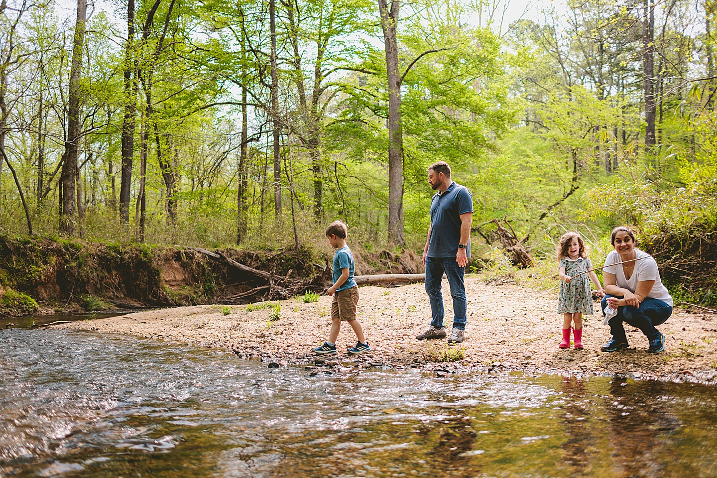 Family playing in creek by their house in Raleigh