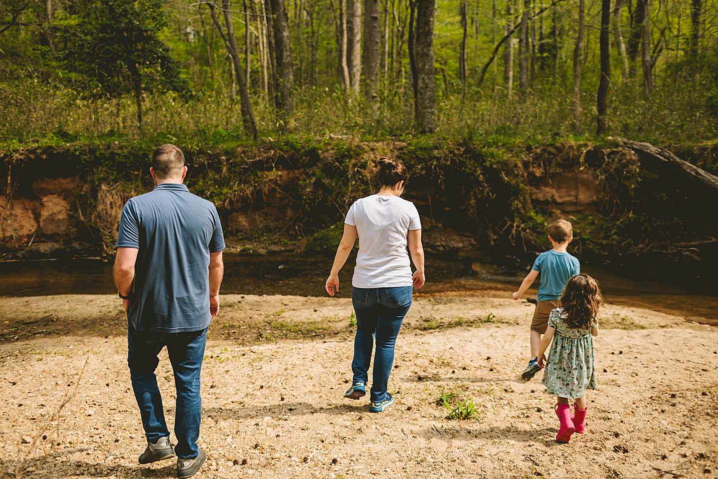 Family playing in creek by their house in Raleigh