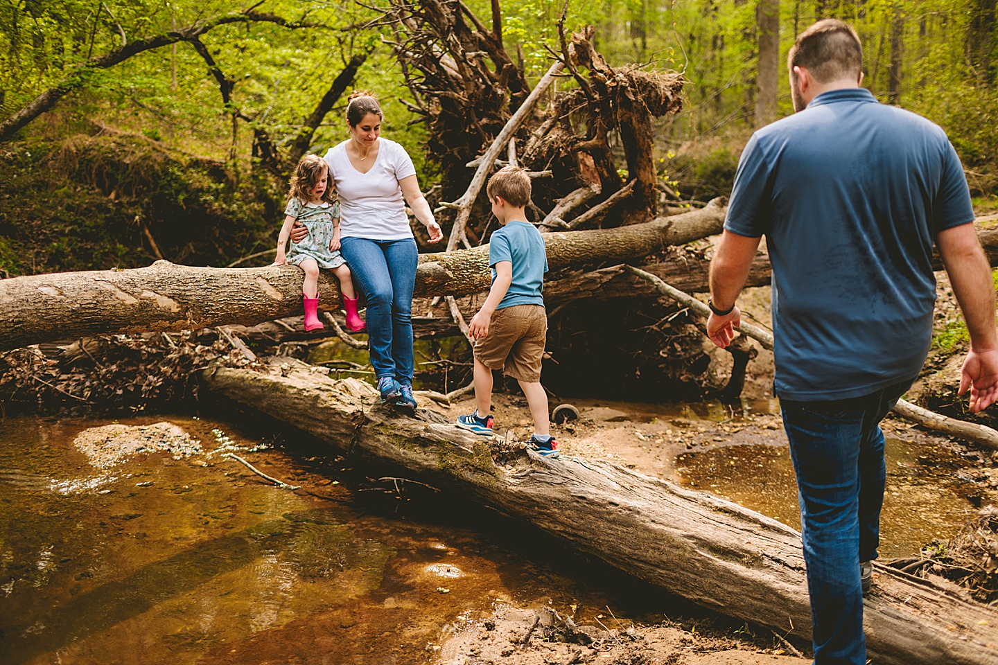 Family playing in a creek near their house in Raleigh