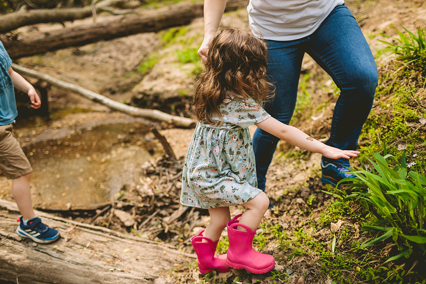 Girl walking across a creek