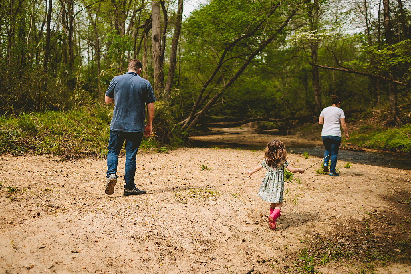 Family walking alongside a creek