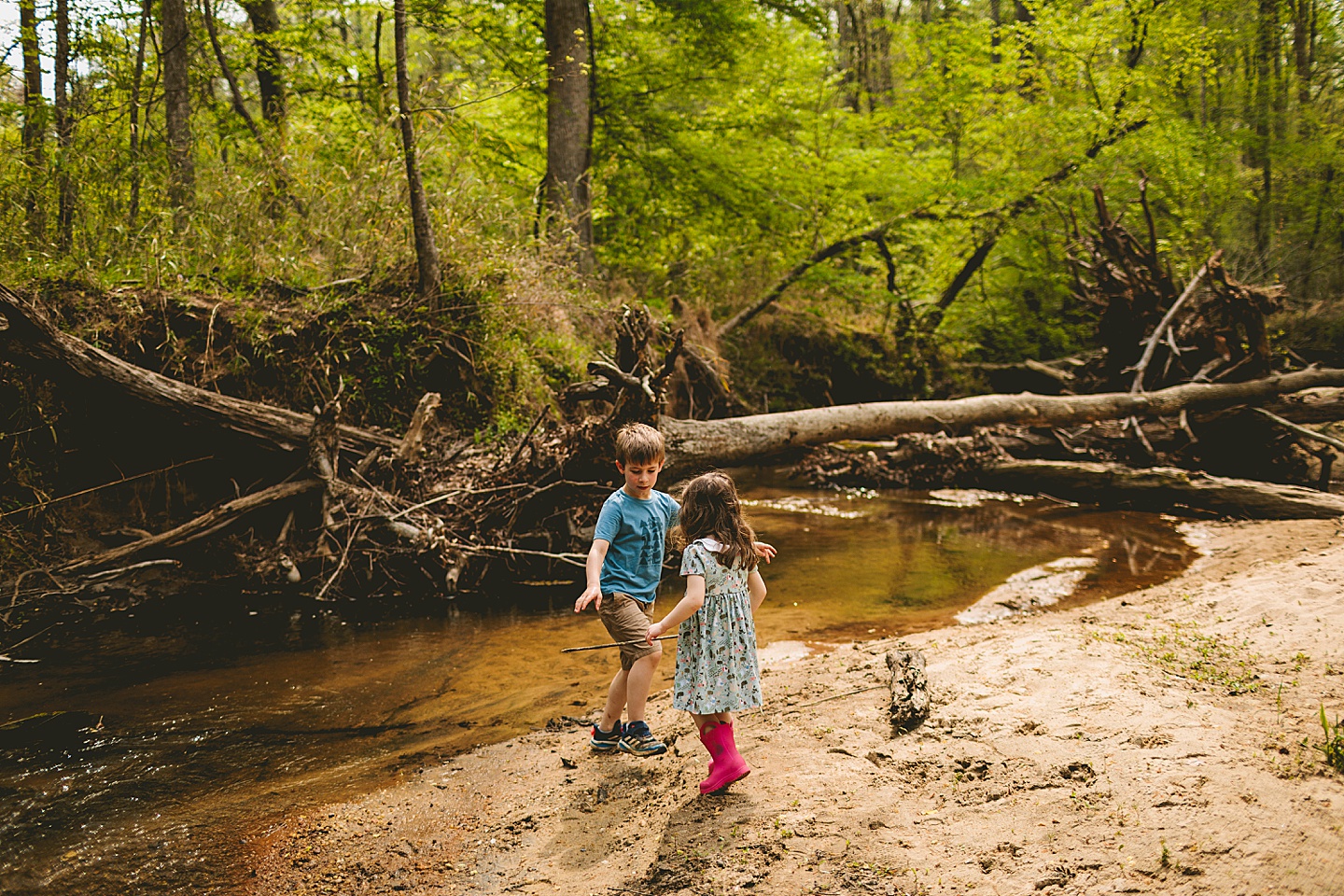 Kids playing by the side of a creek