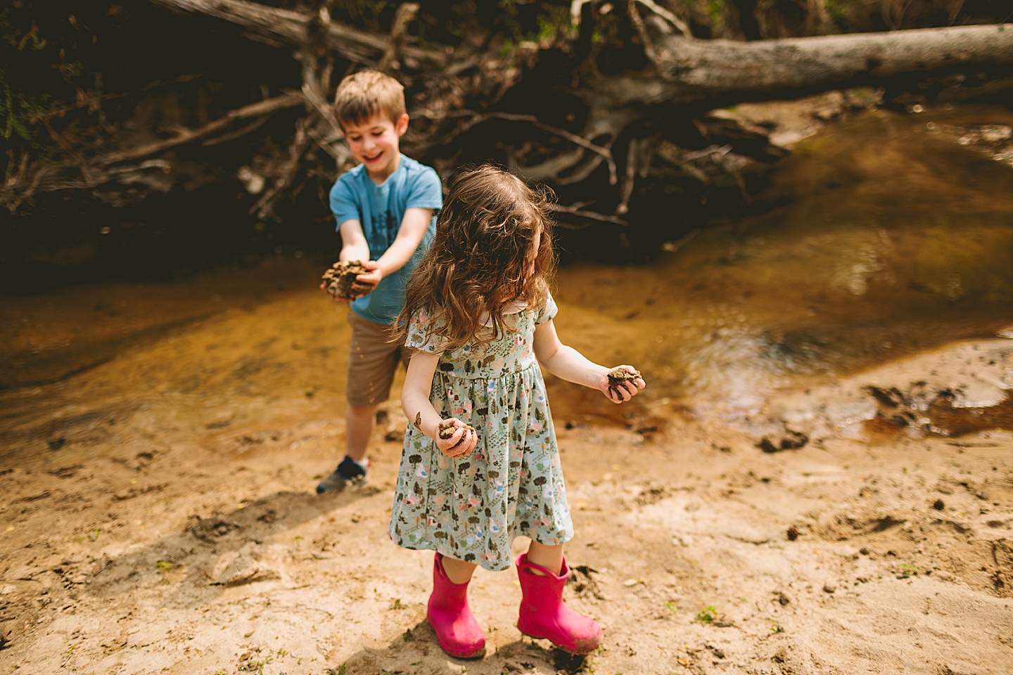 Brother and sister playing in creek in Raleigh during family photographs