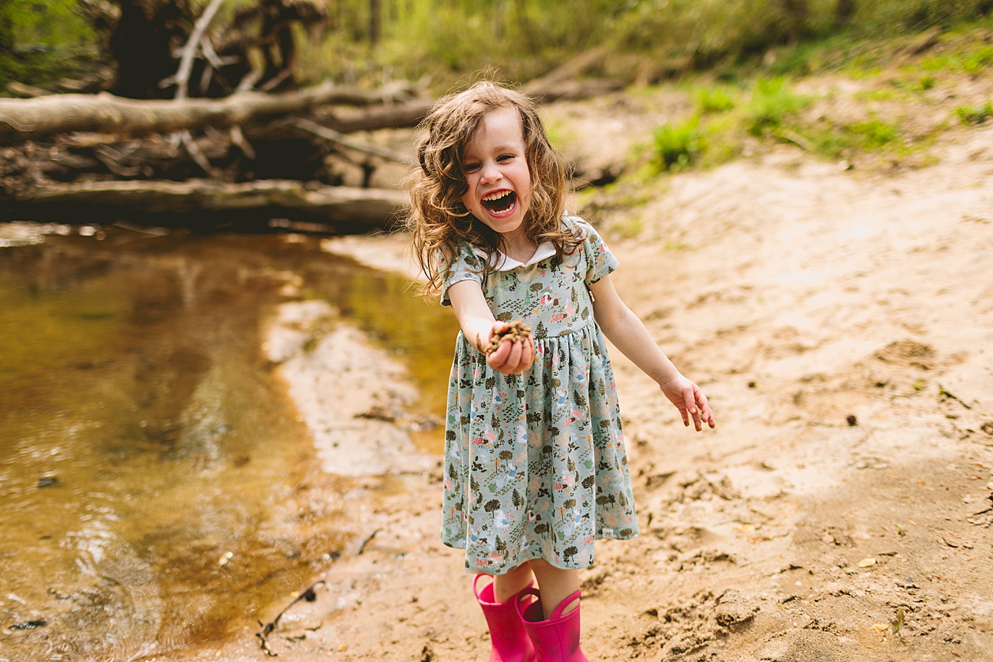 Girl laughing holding sand