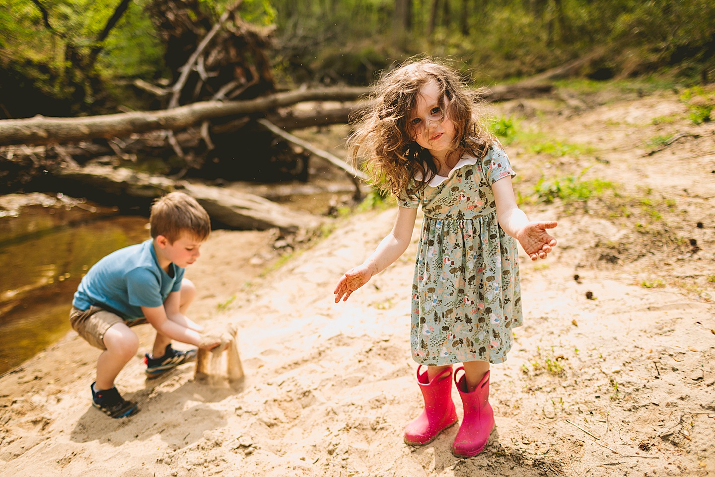 Brother and sister playing in creek in Raleigh during family photographs