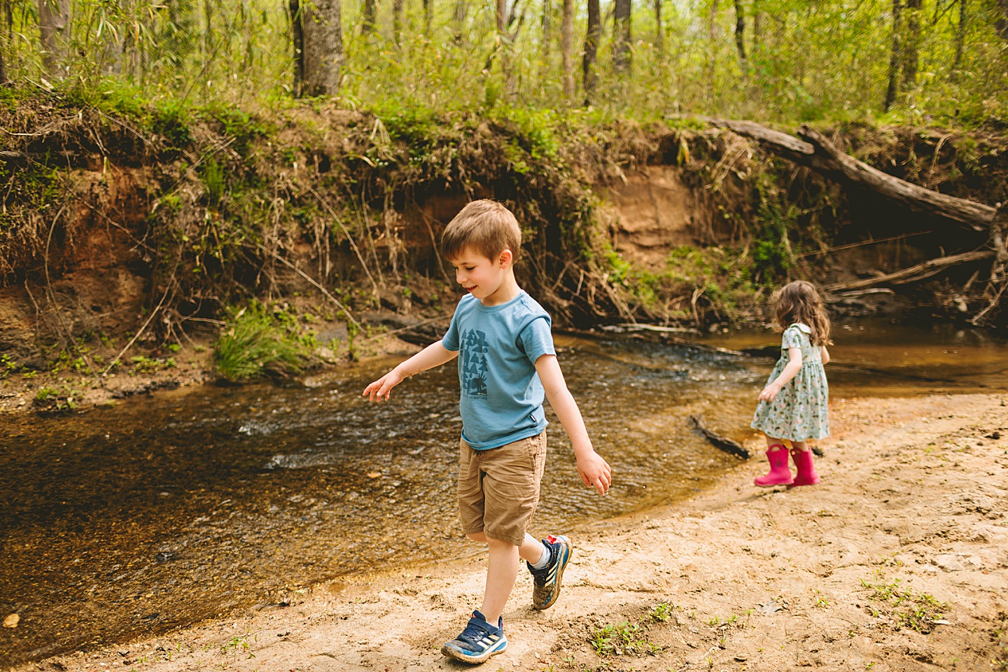 Brother and sister playing in creek in Raleigh during family photographs