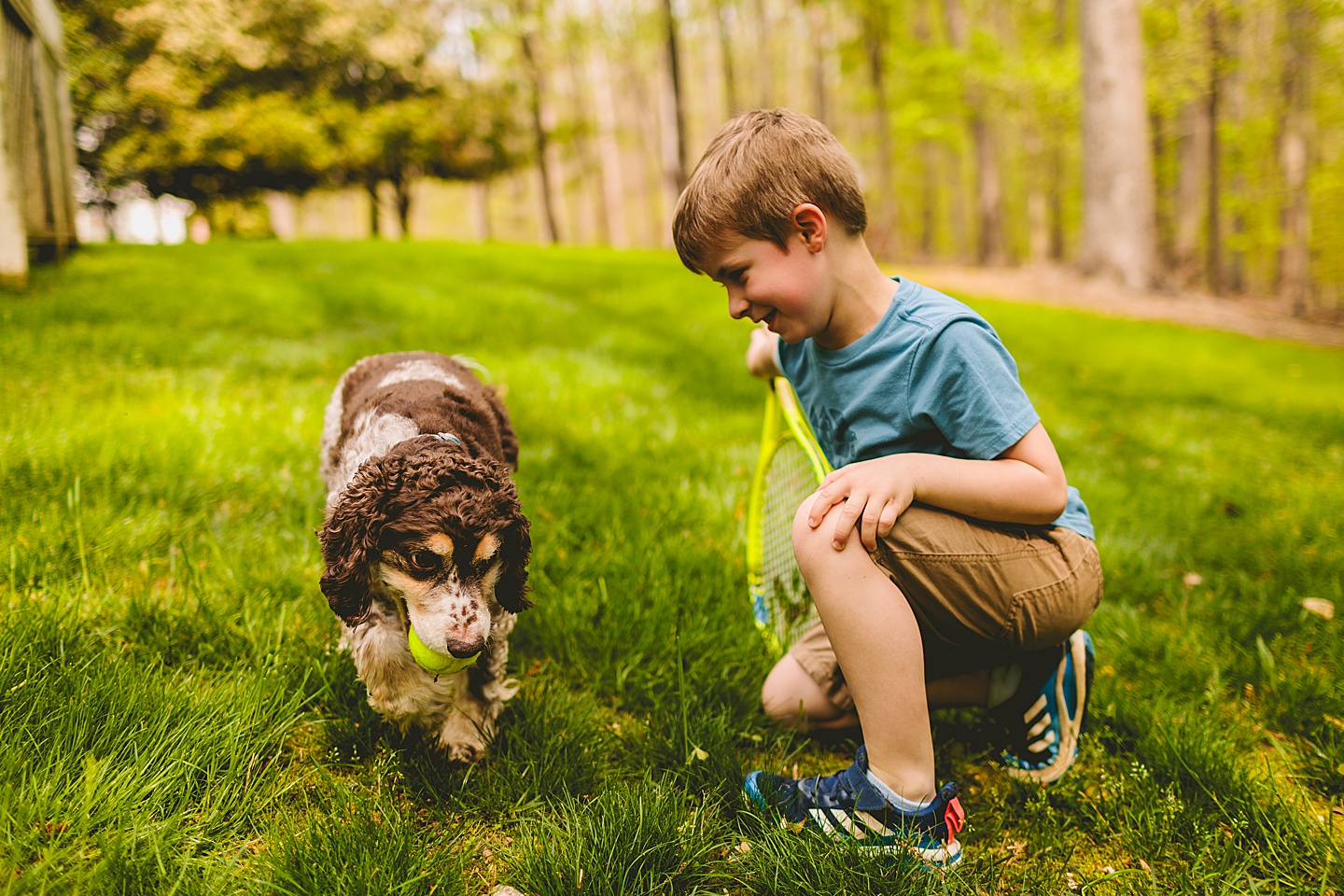 Kid sitting with his dog