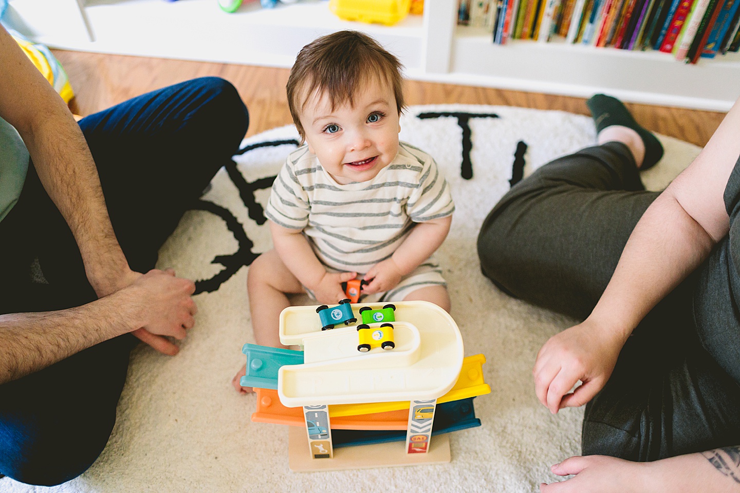 Baby smiling with toy cars