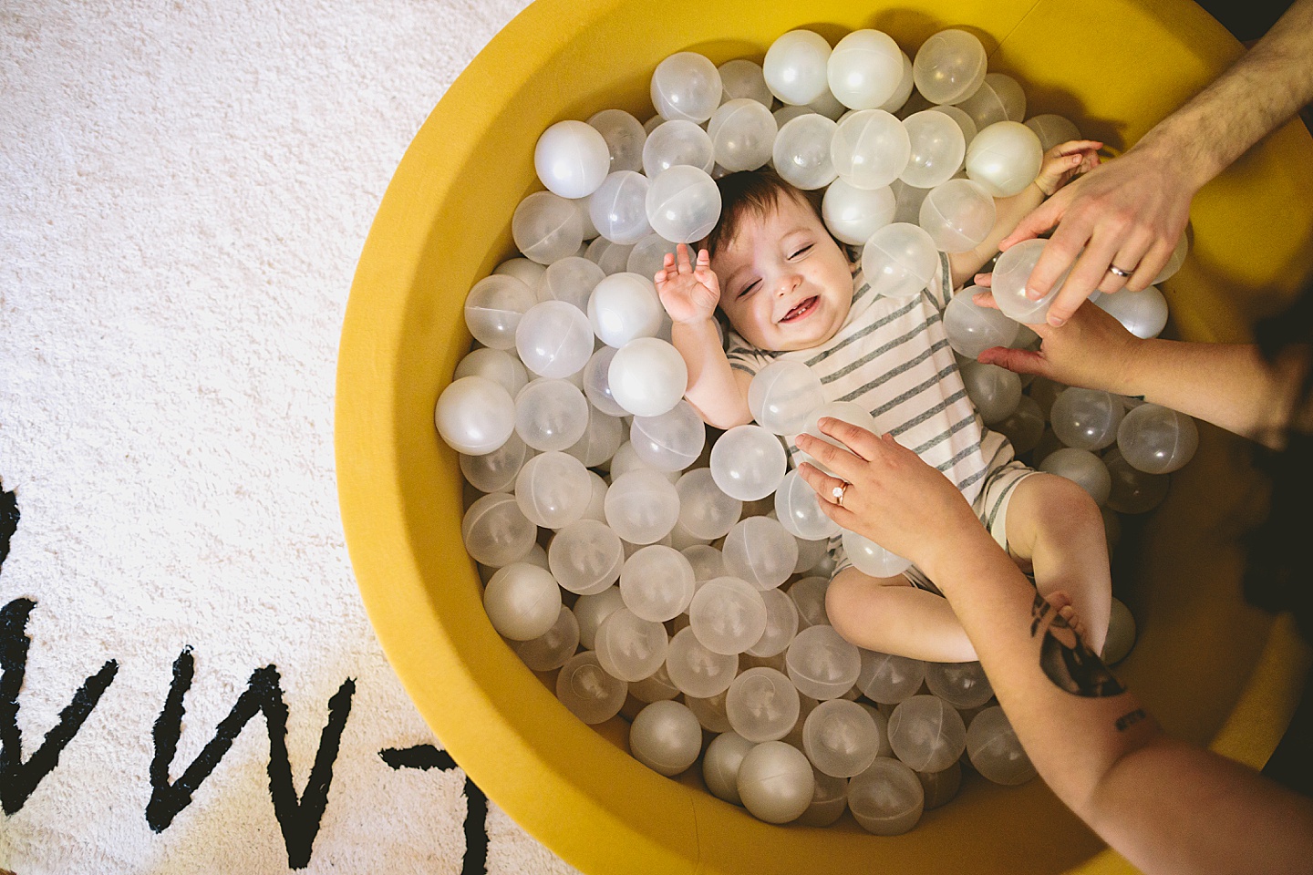 Baby playing in ball pit