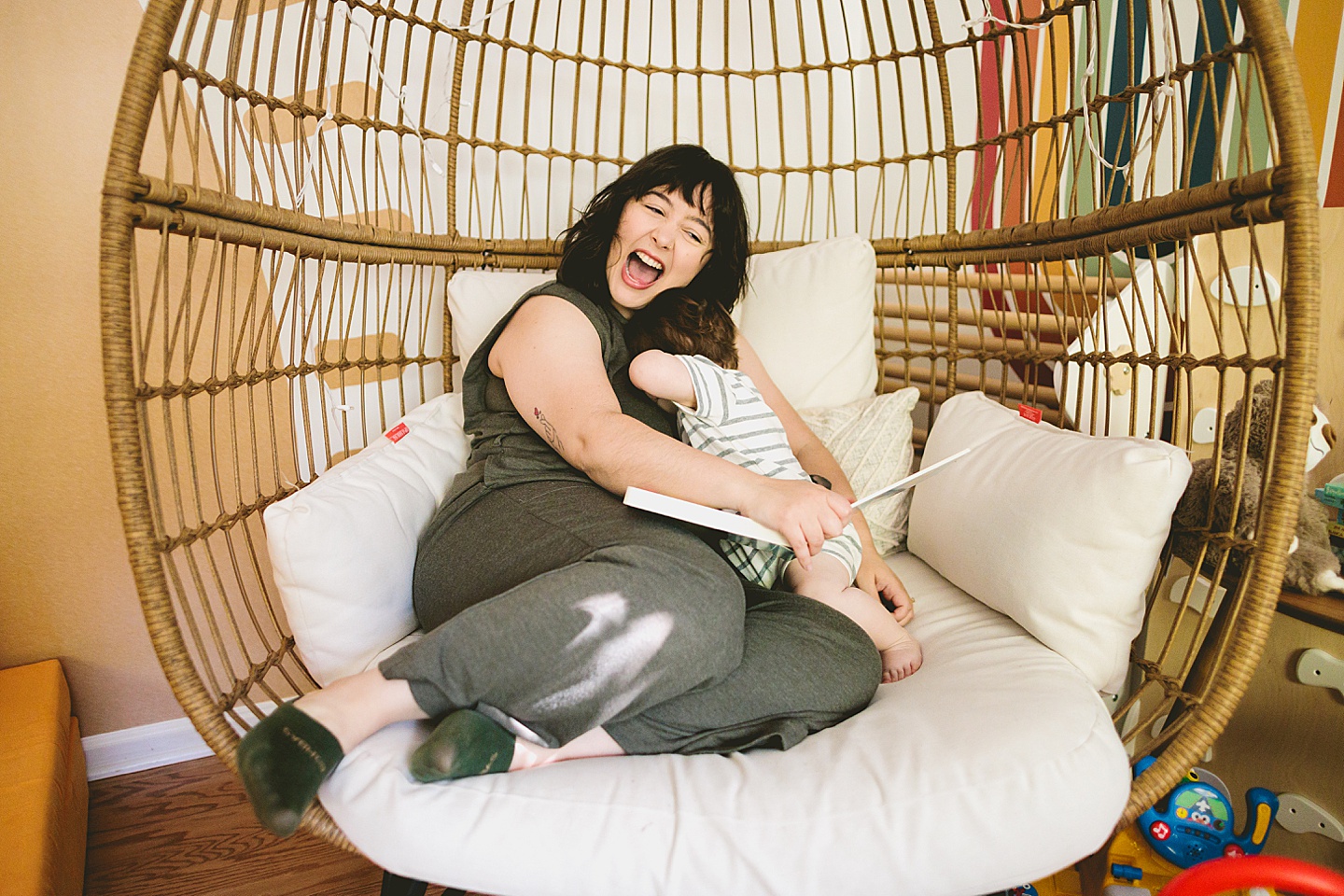 Mom reading storybook to one year old baby