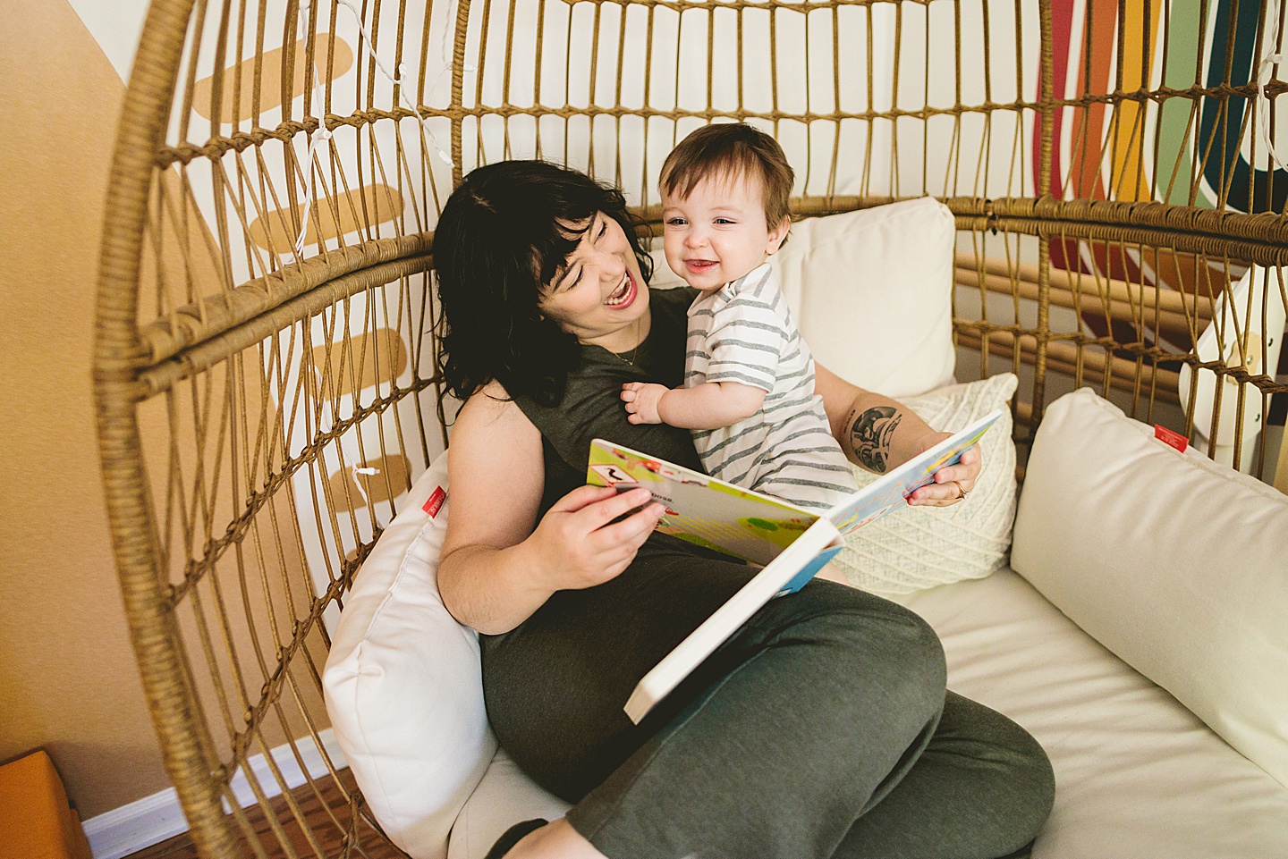 Mom reading storybook to one year old baby