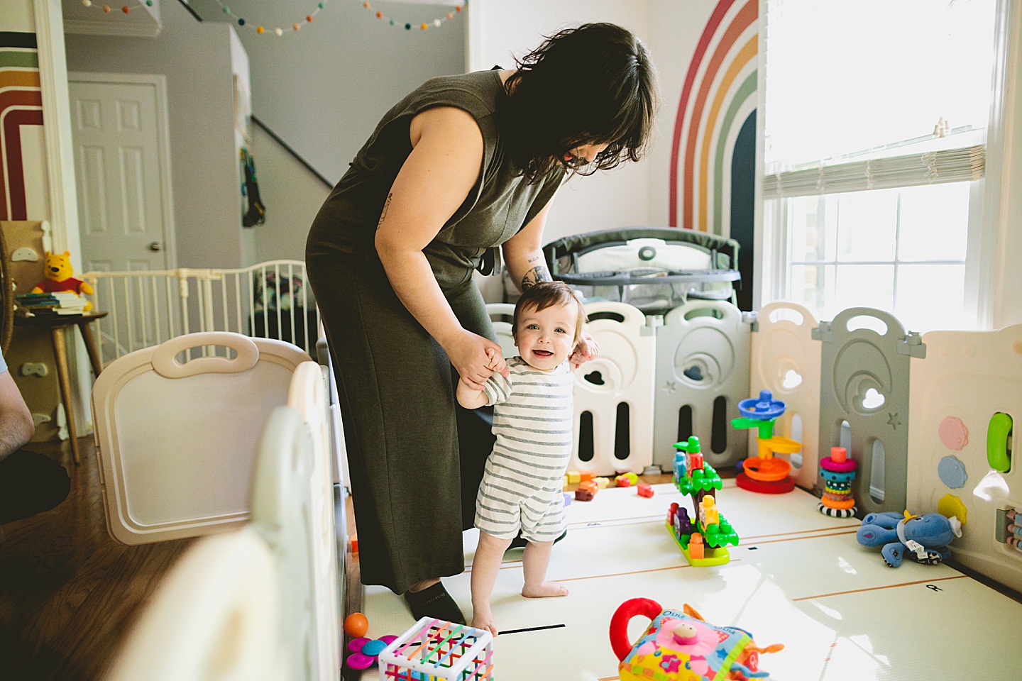 Mom holding hands with baby and walking