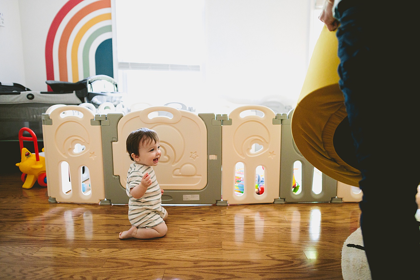 Baby sitting on floor and laughing