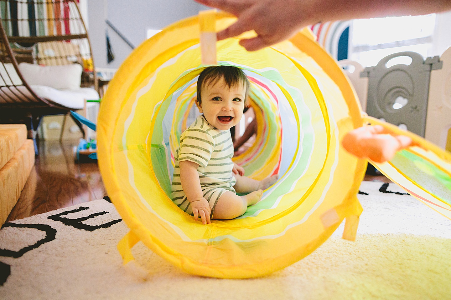 Baby crawls into rainbow tunnel