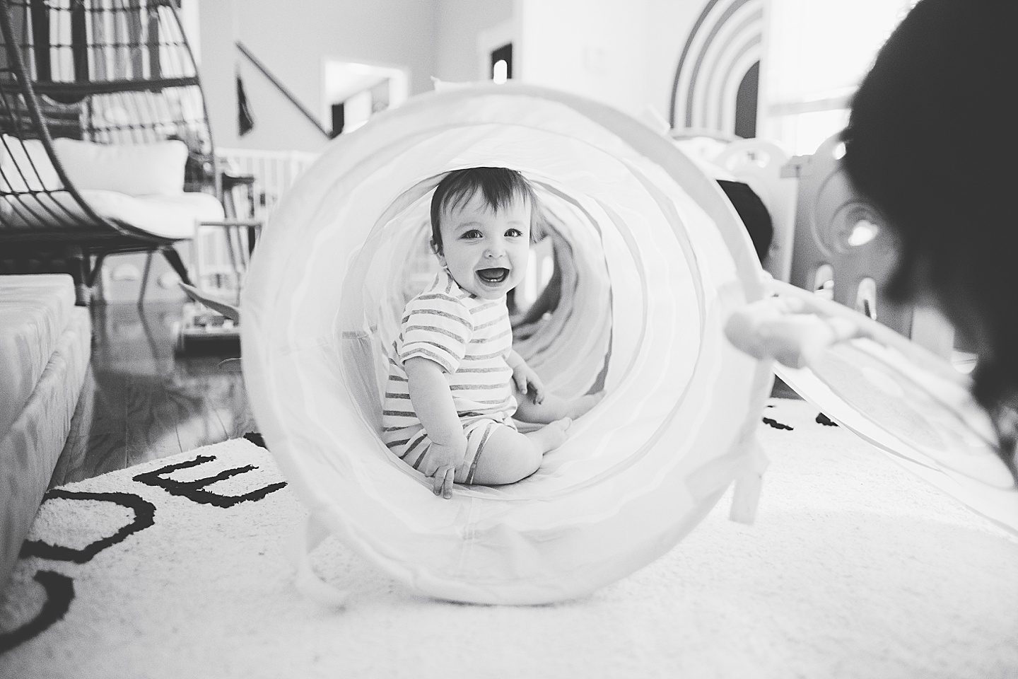 Smiling baby inside tunnel toy