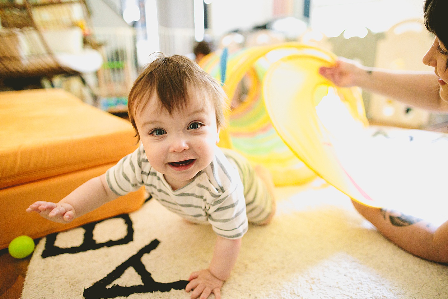 Baby crawls into rainbow tunnel