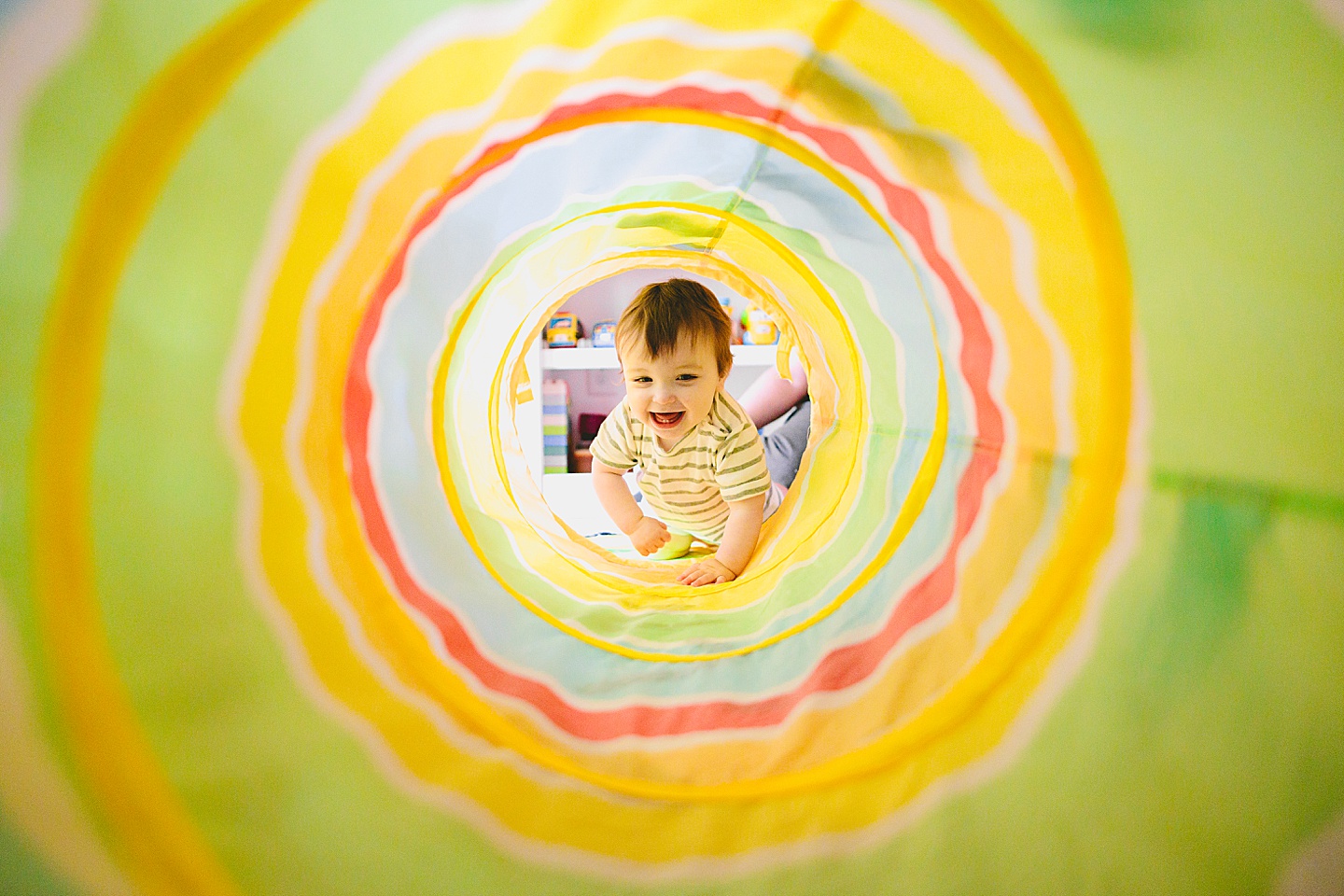 Baby crawls into rainbow tunnel