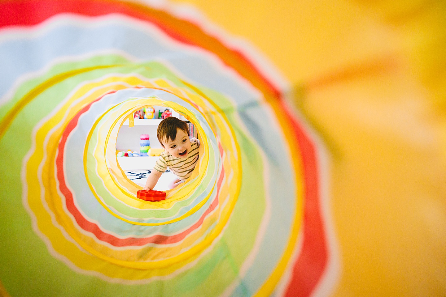 Baby crawls into rainbow tunnel