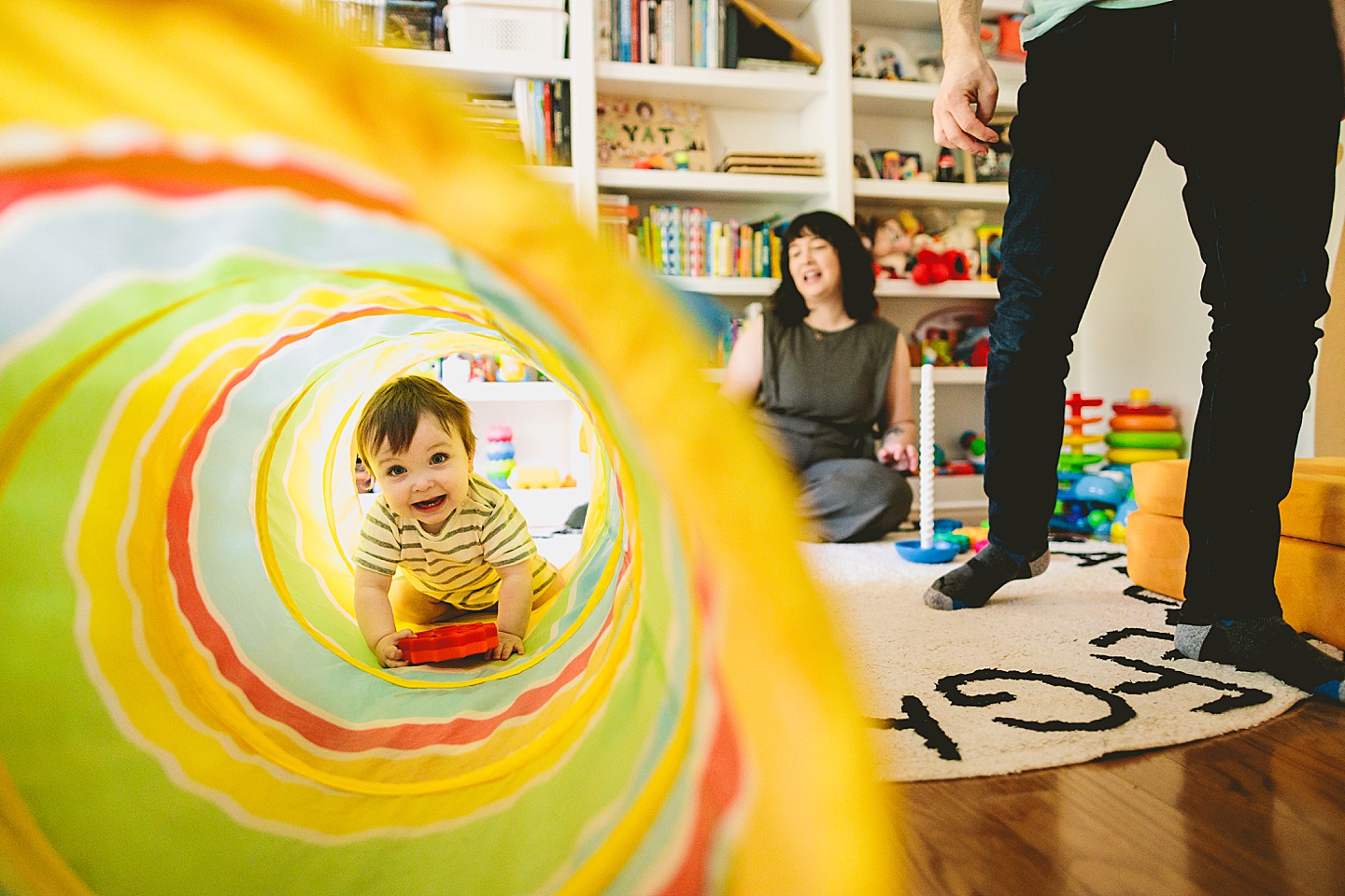 Baby crawls into rainbow tunnel