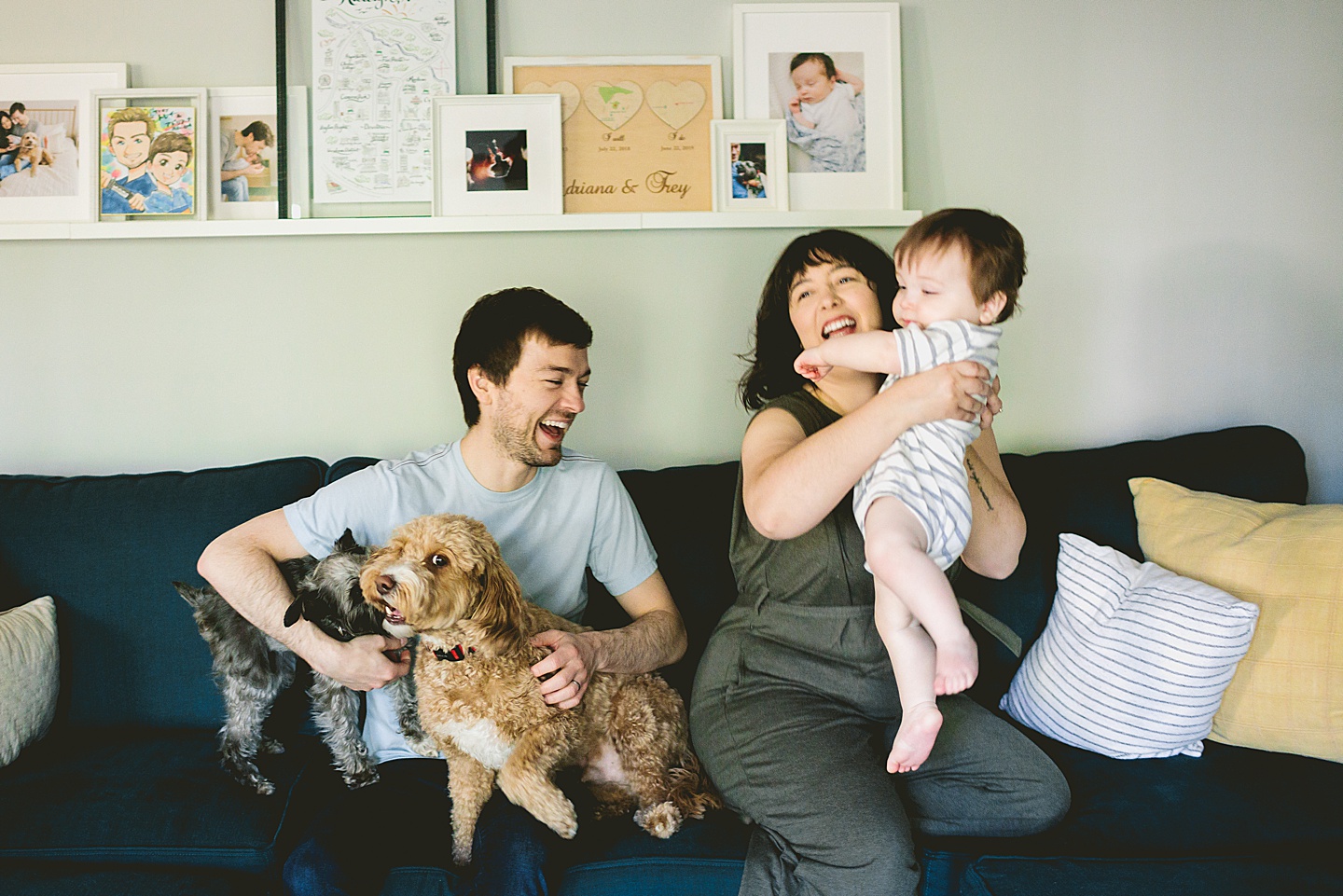 Family laughing and sitting on couch together