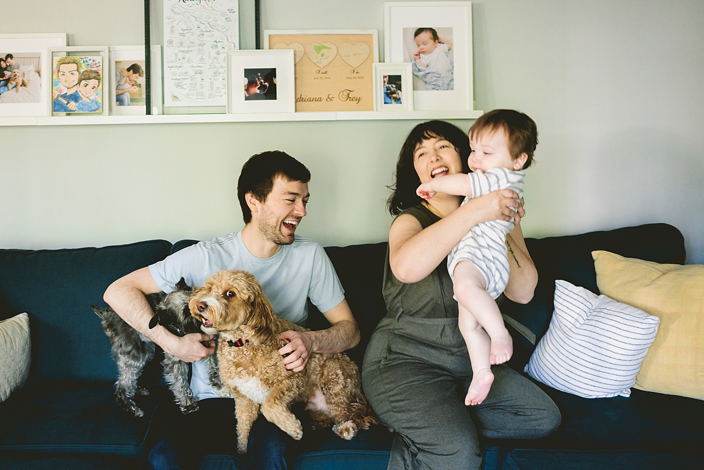 Family laughing and sitting on couch together