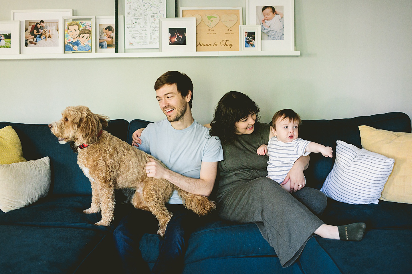 Family laughing and sitting on couch together