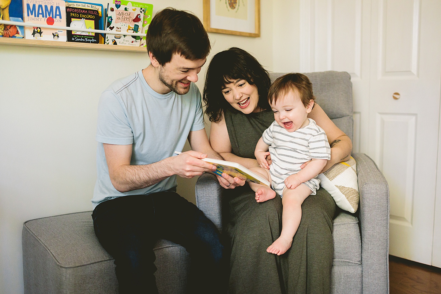 Parents reading to one year old baby