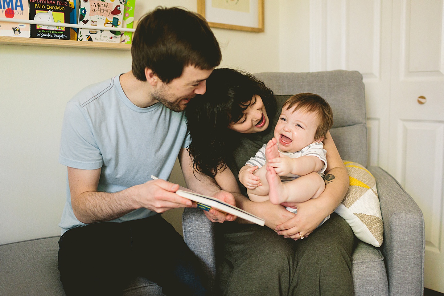 Parents reading to one year old baby