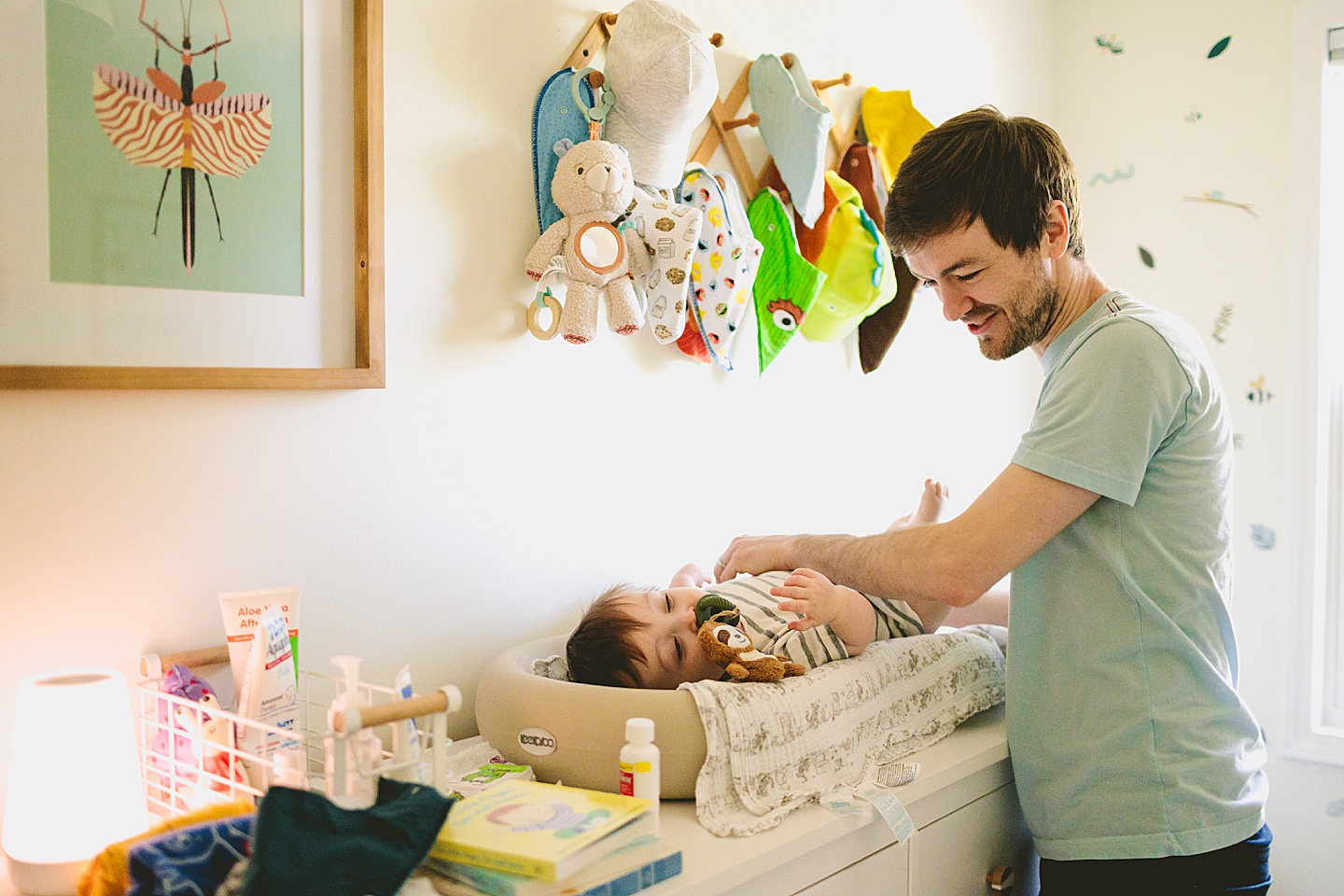 Dad helping baby get his outfit changed for family portraits
